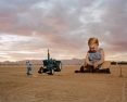 Baby with Tractor at Sunset
